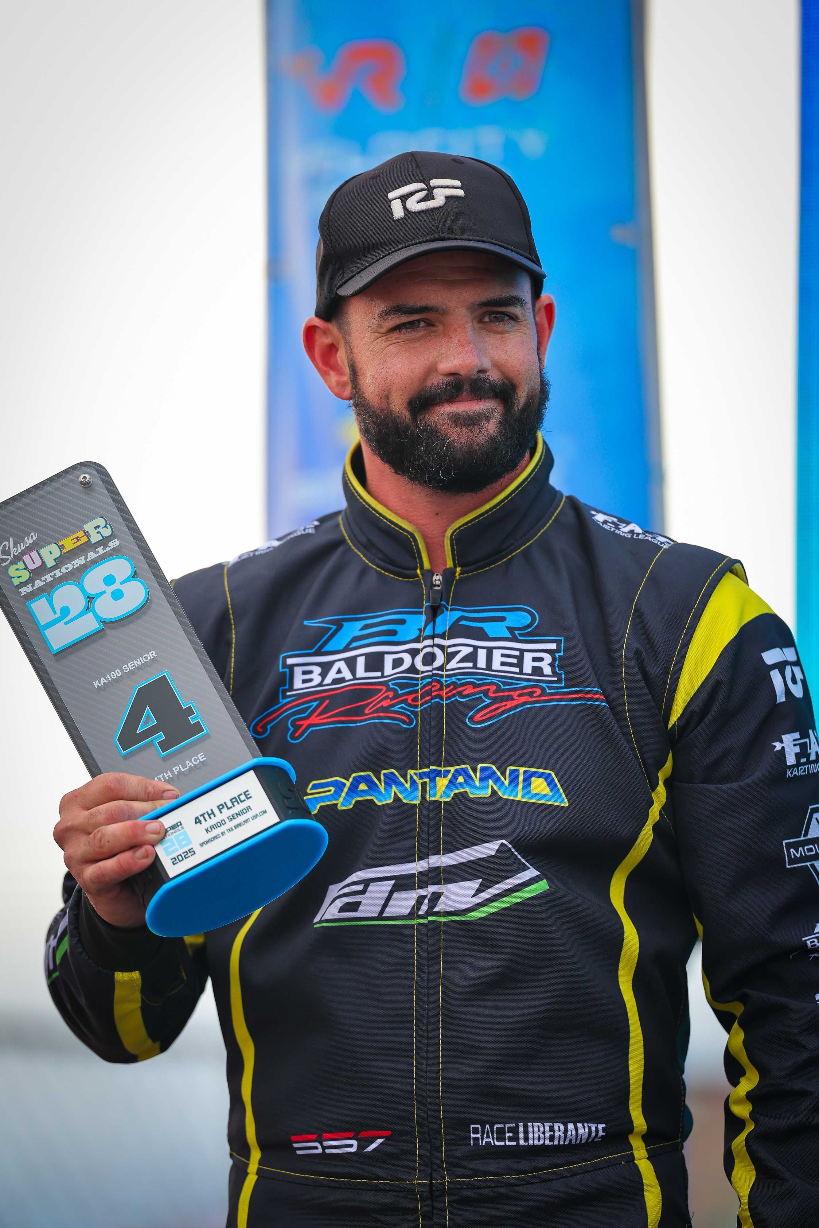 Race Liberante holding a racing award